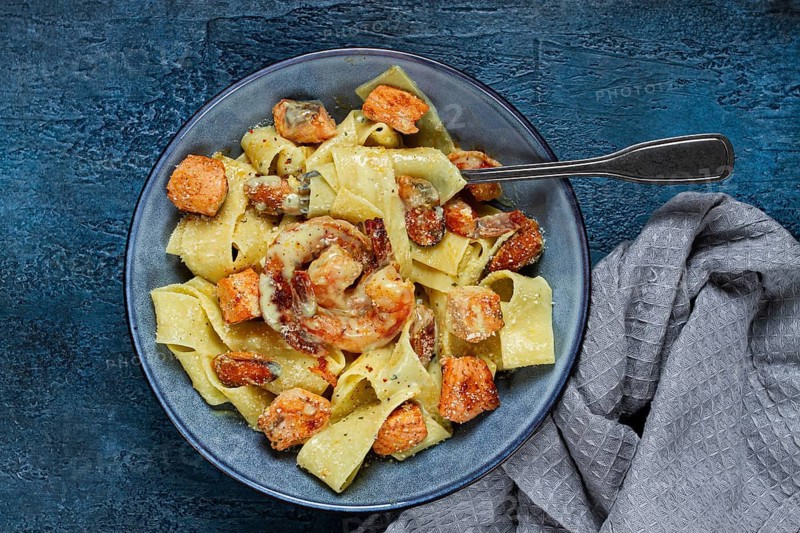 Papardelle pasta in creamy sauce with seafood, homemade, no people