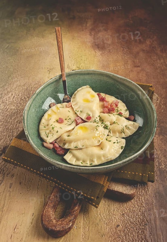 Dumplings, with fried prosciutto, a traditional dish of Polish cuisine, dumplings, top view, close-up, without people