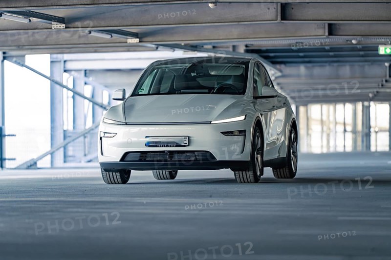Electric car with modern shapes in a dimly lit car park, Tesla New Model Y Juniper, Calw, Germany, Europe