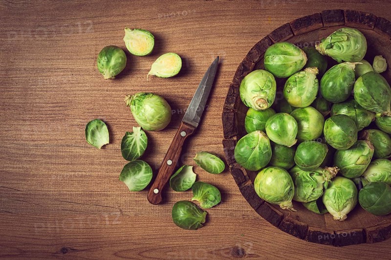 Fresh Brussels sprouts, raw, top view, on a wooden table, no people