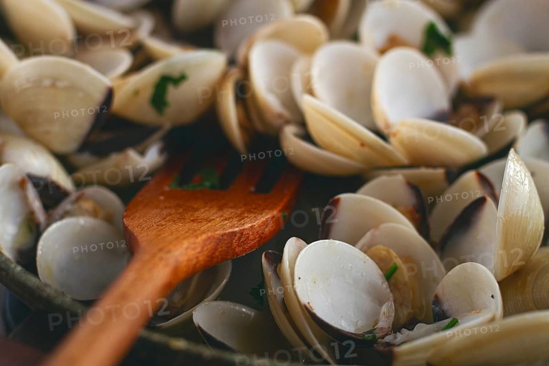 Cooking, vongole clams, in a pan with spices and white wine, top view, no people