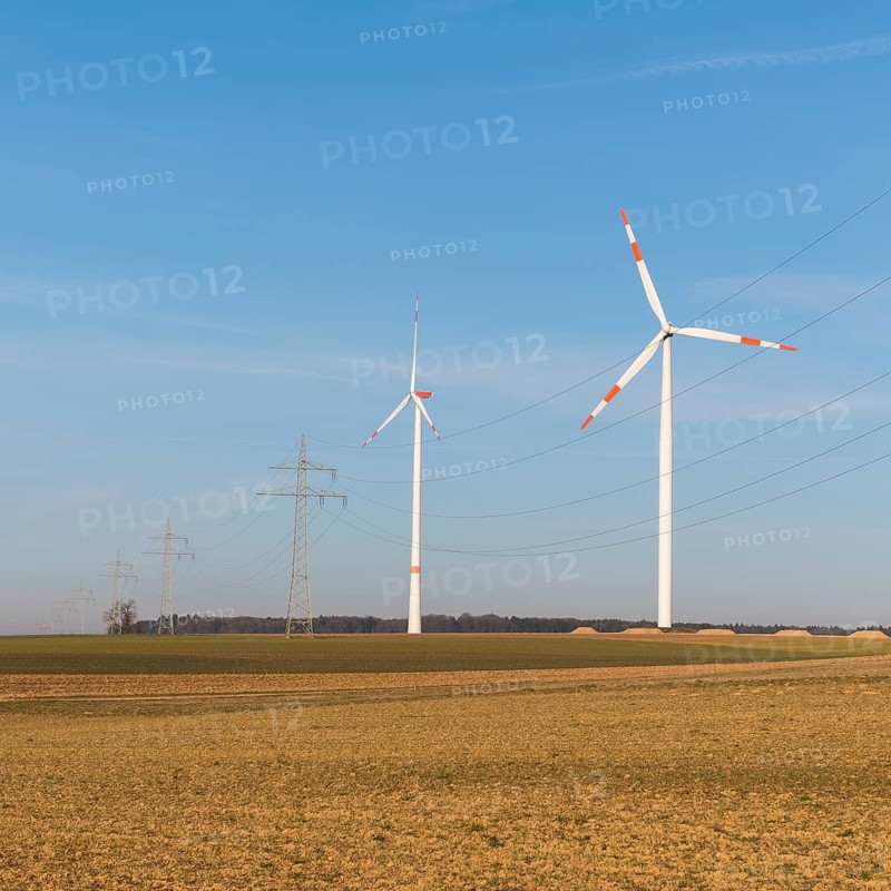 Wind turbines and power lines in an autumnal field under a clear sky, solar park, near Ulm, Swabian Alb, Baden-Württemberg, Germany, Europe
