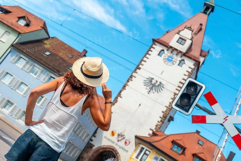 A female tourist at the Kinzigtor tower in the village of Gengenbach in the Black Forest, Germany, Europe