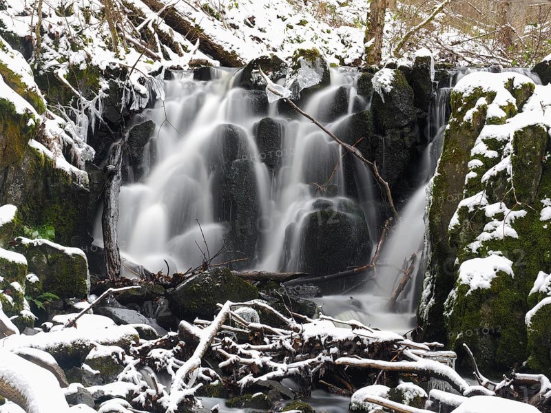 Teufelsmühle waterfall on the hill stream the Schwartzbach, in snow and ice in November. The Rhön UNESCO Biosphere nature reserve, county Bavaria, Germany, Europe