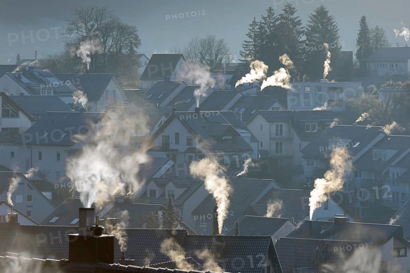 Smoke rising from the chimneys of a housing estate at dawn, Korb im Remstal, Baden-Württemberg, Germany, Europe
