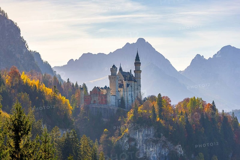Romantic castle enthroned in autumnal forests against a mountain backdrop, Neuschwanstein, Schwangau, Ostallgäu, Allgäu, Swabia, Upper Bavaria, Bavaria, Germany, Europe
