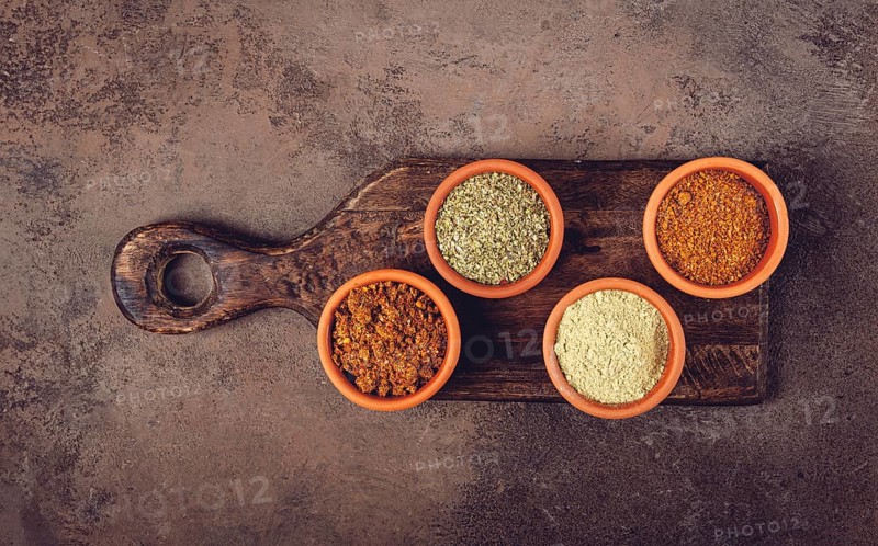 Georgian spices, in ceramic bowls, assortment, set of spices, utsho, adjika, Svan salt, ground coriander, top view, no people
