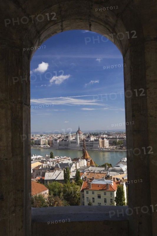 Budapest city skyline with Danube river and Hungarian parliament through stone arch in summer, Hungary, Europe