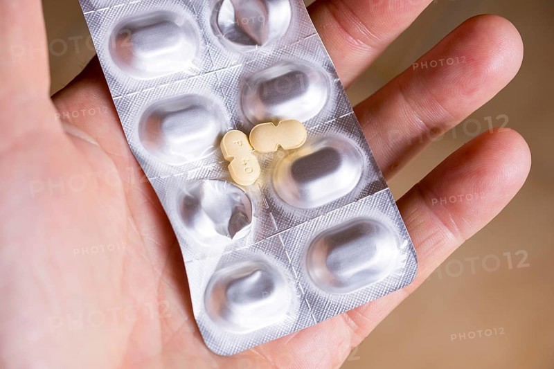 Hand holding a blister pack with tablets