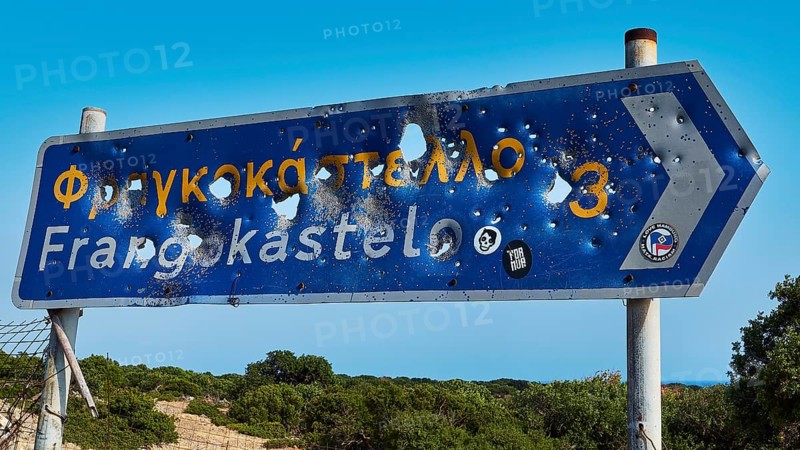 Road sign, bullet holes, shot up road sign, Frangokastello, Venetian fortress, fortress, Sfakia, West Crete, south coast, island of Crete, Greece, Europe