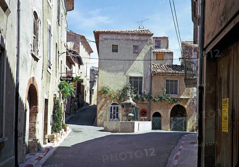 Attractive historic buildings in the village street of Venasque, Vaucluse, Provence, France 1974