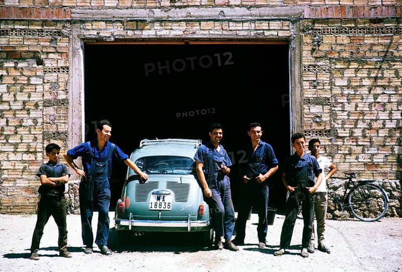 Mechanics standing next to a SEAT 600 car, Spain 1964