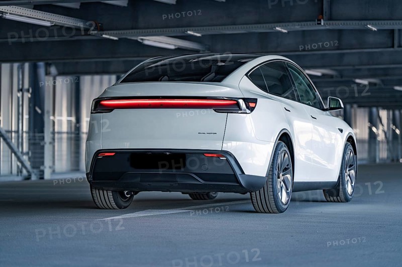 Rear of a modern electric car with eye-catching LED strip in a multi-storey car park, Tesla New Model Y Juniper, Calw, Germany, Europe