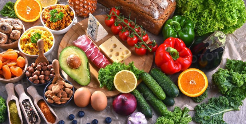 Composition with assorted food products on kitchen table