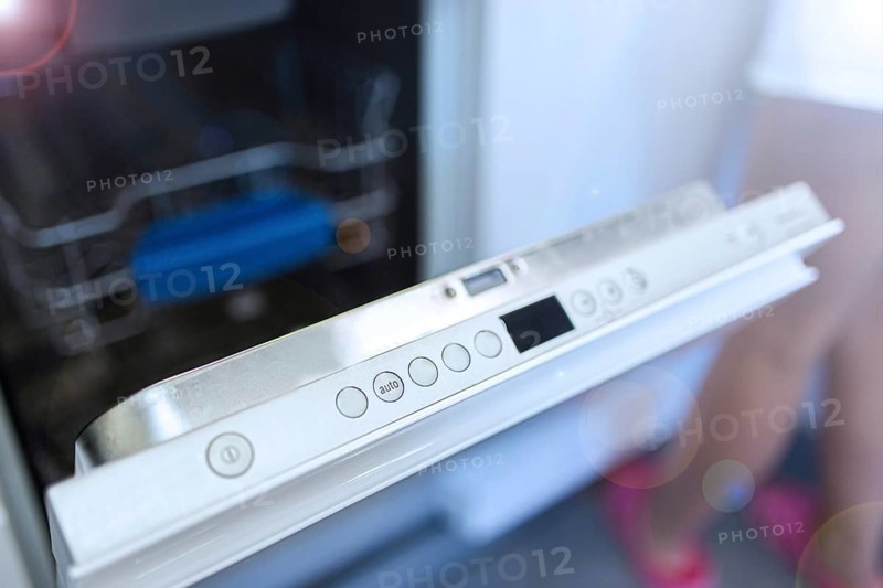 Dishwasher door partly open, showing control panel buttons