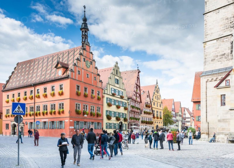 DINKELSBUEHL, GERMANY - SEPTEMBER 27: Tourists in the old town of Dinkelsbuehl, Germany on September 27, 2015. It is one of the best preserved medieaval towns in Germany. Foto taken from Marktplatz with view to the historic house facades
