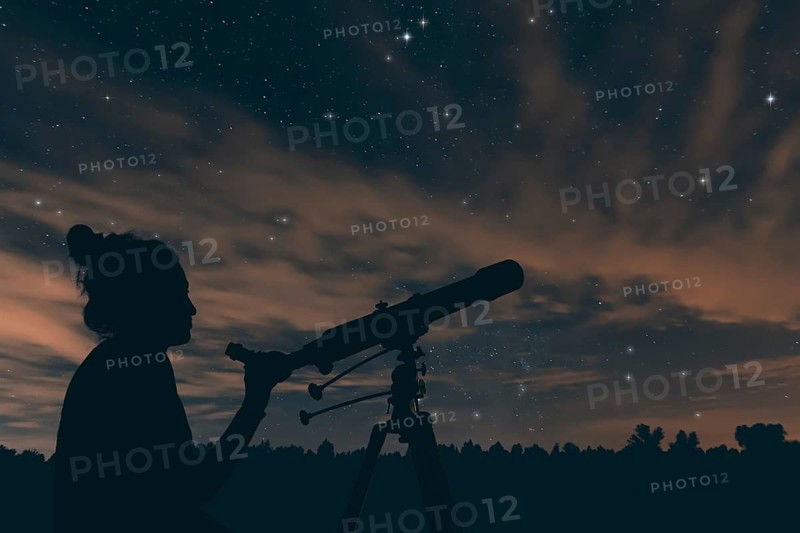 Woman with telescope. Night sky, with clouds and constellations, Aquarius, Aguila, Scutum, Ophiuchus, Serpens, Sagittarius, Capricornus
