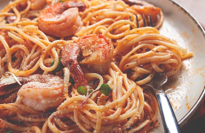 Spaghetti with tiger prawns, in tomato sauce, homemade, top view, no people