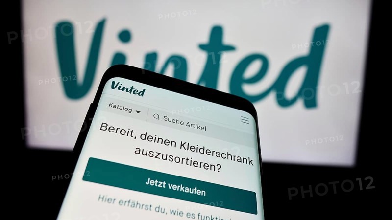 Stuttgart, Germany, 03-17-2024: Mobile phone with website of online secondhand marketplace company Vinted in front of business logo. Focus on top-left of phone display, Europe