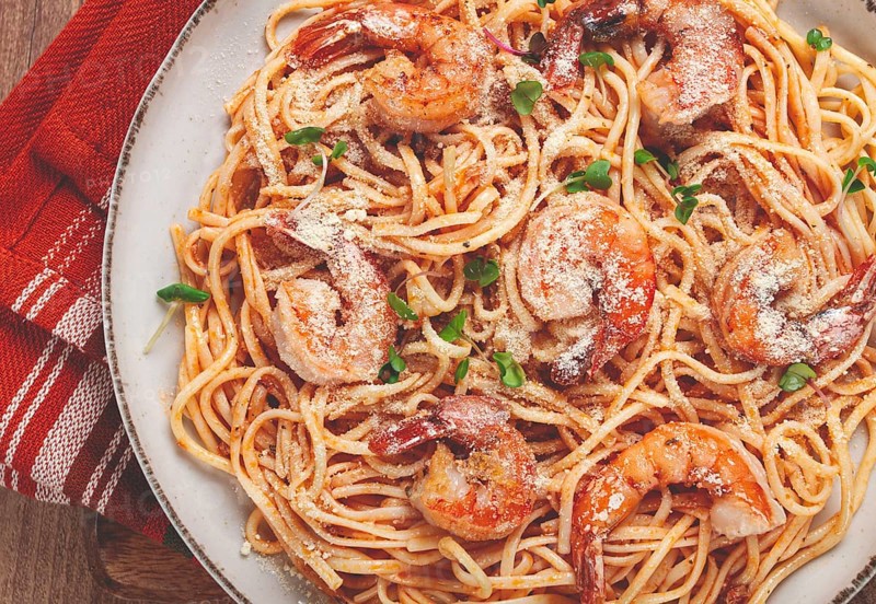 Spaghetti with tiger prawns, in tomato sauce, homemade, top view, no people