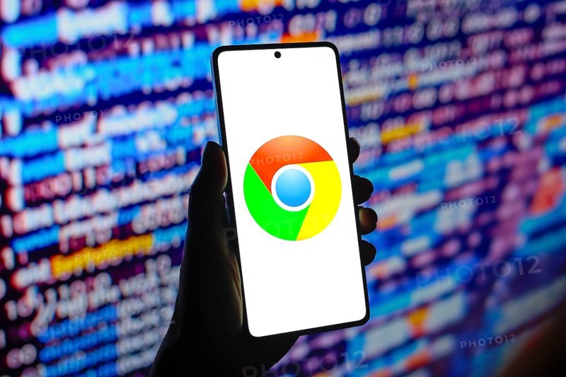In this photo illustration, the web browser Google Chrome logo is displayed on a smartphone screen