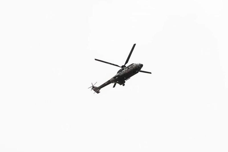 Photo of Military navy helicopter flying isolated on white background