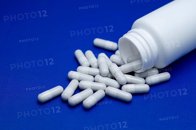 Large white pills fell from a large white bottle. Life without drugs and dependence on capsules of antibiotic, medicine, amphetamines, drugs and drugs. Concept of drug withdrawal drugs. Bulgaria