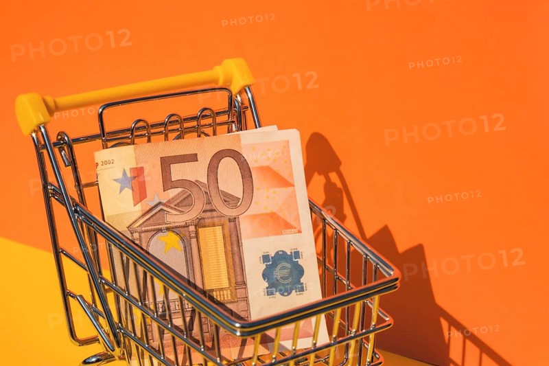Euro paper currency 50 banknote money Shopping trolley cart on colorful orange yellow background. Copy space for your text. Online shopping, buy mall market shop consumer concept. Small toy supermarket grocery push cart. Food crisis. Rising food cost, grocery prices shortage mass hunger. Inflation