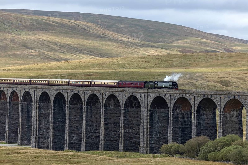 Steam train crossing Ribblehead Viaduct, railway bridge over the valley of the River Ribble at the foot of the mountain Whernside, North Yorkshire, England, Great Britain