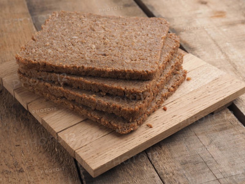 Wholemeal rye bread on a rustic wooden table, healthy food concept