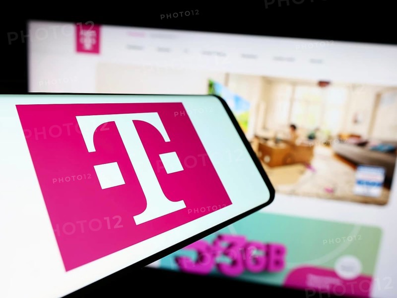 Stuttgart, Germany, 09-11-2023: Mobile phone with logo of telecommunications company Deutsche Telekom AG on screen in front of website. Focus on center of phone display, Europe