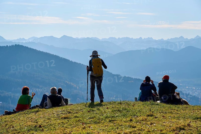 Hikers rest on the summit of Sonntratn, also known as Schürfenkopf, and look into the Karwendel, near Bad Tölz, Bavarian Prealps, Upper Bavaria, Bavaria, Germany, Europe