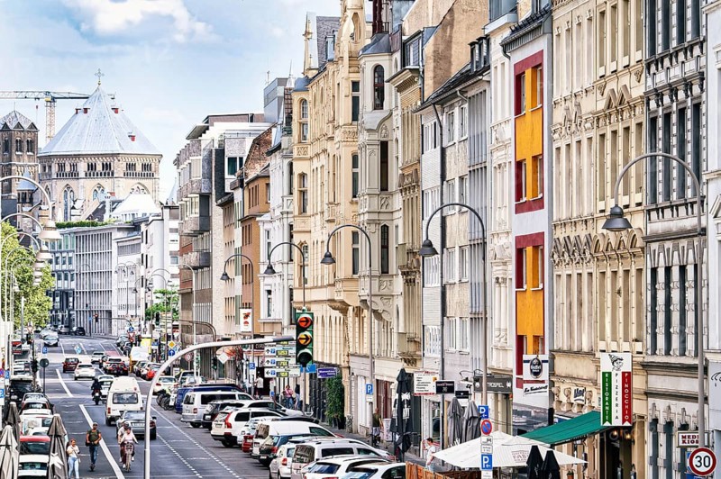 House facades from the end of the 19th century in the Belgian Quarter and the medieval church of St Gereon in Cologne in July 2023