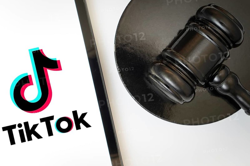 An iPad displays the tiktok logo alongside a judge's gavel