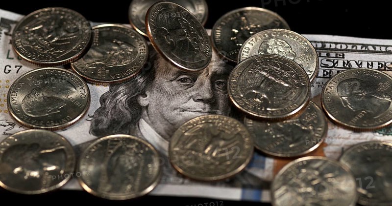 Quarter Dollar Coins Falling, Rolling and Sliding on Black Background