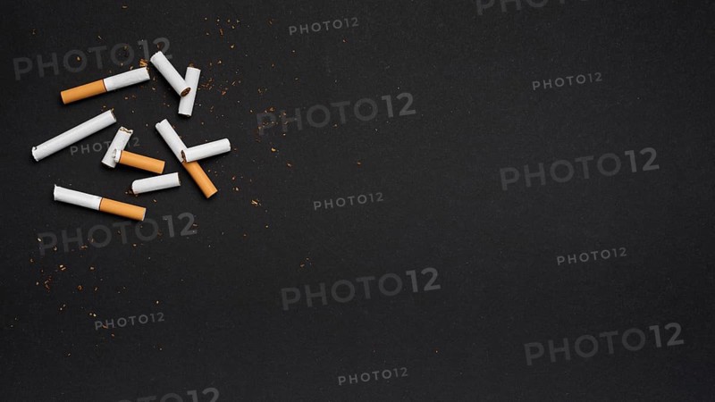 Top view broken cigarette with tobacco black backdrop