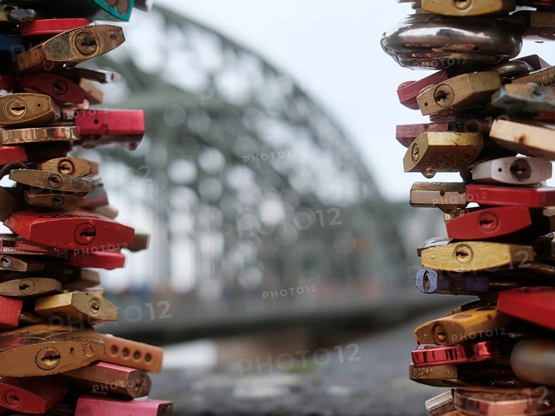 Love locks on a bridge over the Rhine, blurred background, Cologne, Germany, Europe