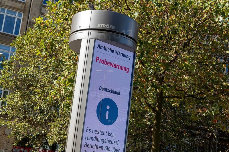 Symbolic image disaster control, advertising pillar with the display Official warning, test warning, city centre, Hamburg, Germany, Europe