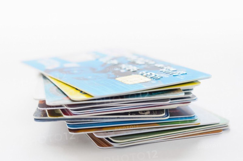A pile of several colored credit cards
