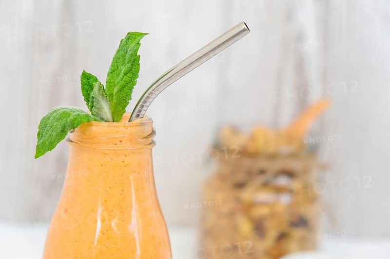 Seasonal pumpkin carrot smoothie drink detox with eco metal drinking straw Glass jar granola muesli oatmeal breakfast. Orange smoothie. Clean eating, weight loss, healthy dieting food concept Fruit vegetable drink fitness