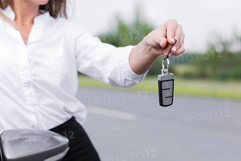 Close up woman holding car keys