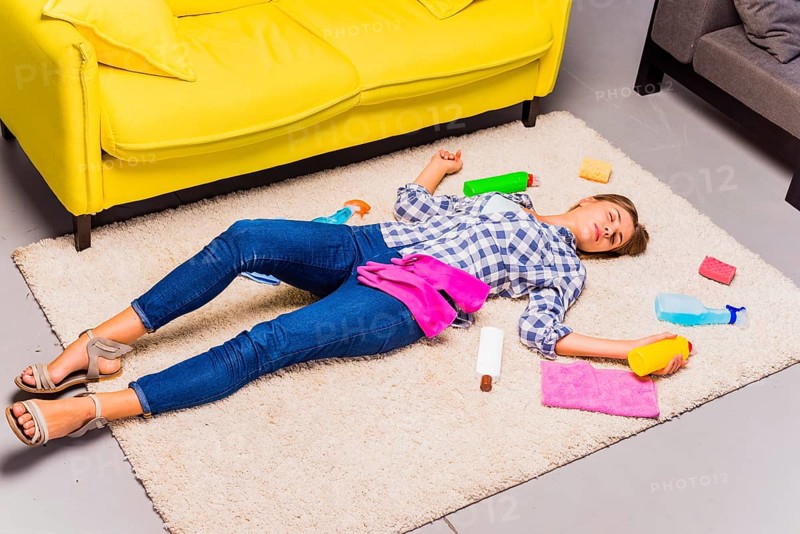 Exhausted young woman after cleaning house