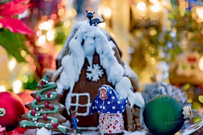 Hansel and Gretel gingerbread house with Christmas decorations and bokeh
