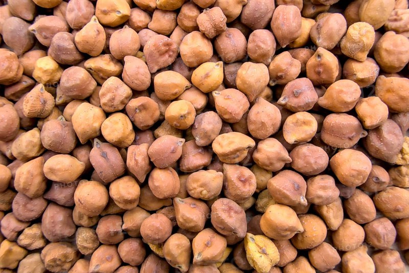 Full-Frame Close-Up of Black or Brown Chickpeas with Textured Details, Top View