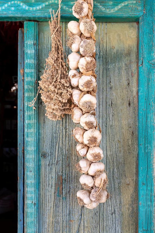 Garlic bulbs braided into a plait, hanging