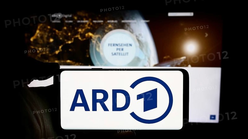 Stuttgart, Germany, 04-10-2024: Person holding cellphone with logo of German public-service broadcasting organisation ARD in front of webpage. Focus on phone display, Europe