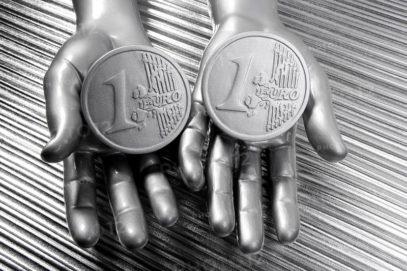 Two silver euro coins in futuristic robot gray metallic hands bank metaphor