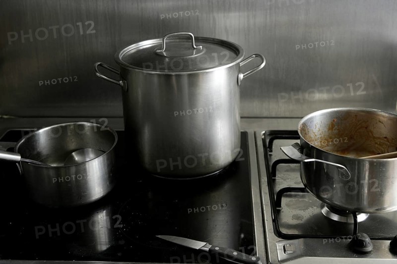 Dirty used stainless steel kitchen cooking stuff, pans