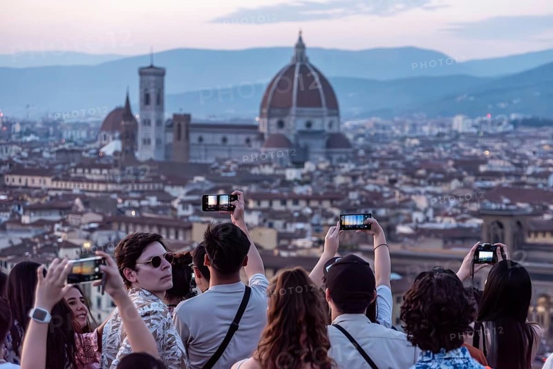 FLORENCE, ITALY, SEPTEMBER 21, 2023, Large tourist crowd on Piazzale Michelangelo enjoying sunset over Florence, Italy, Europe
