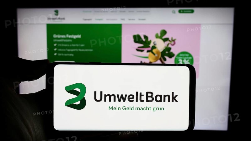 Stuttgart, Germany, 02-12-2024: Person holding cellphone with logo of German financial services company Umweltbank AG in front of business webpage. Focus on phone display, Europe